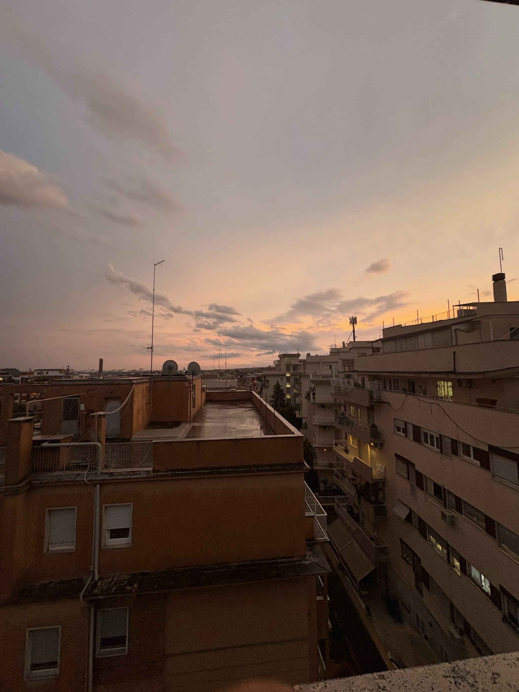 A soft sunset over apartment rooftops