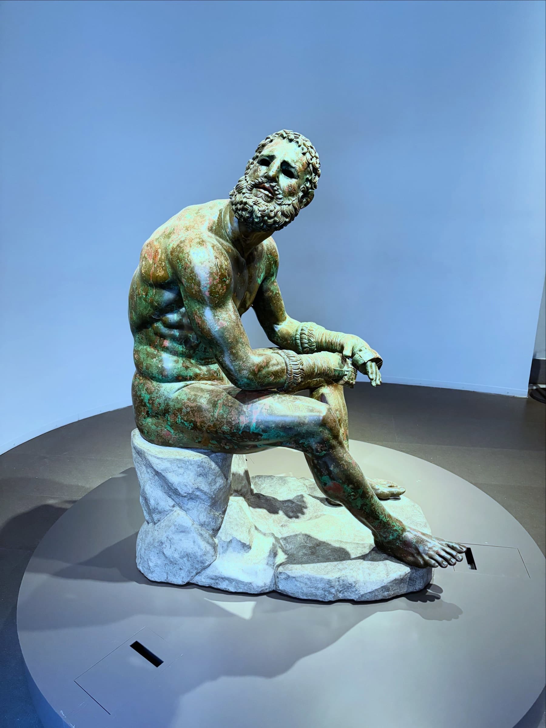 The bronze Terme Boxer seated on a plinth