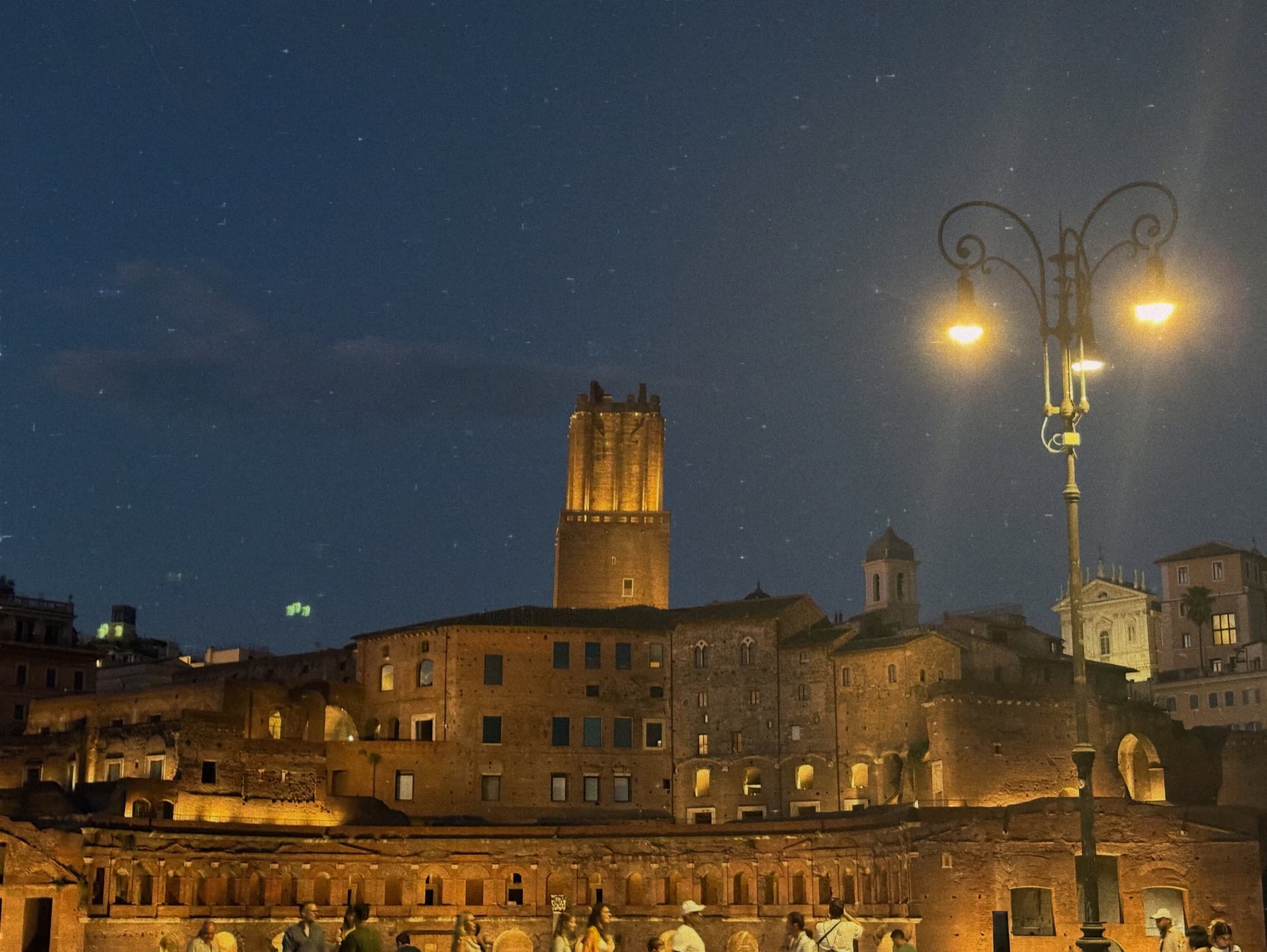 Ancient ruins and a medieval tower at dusk