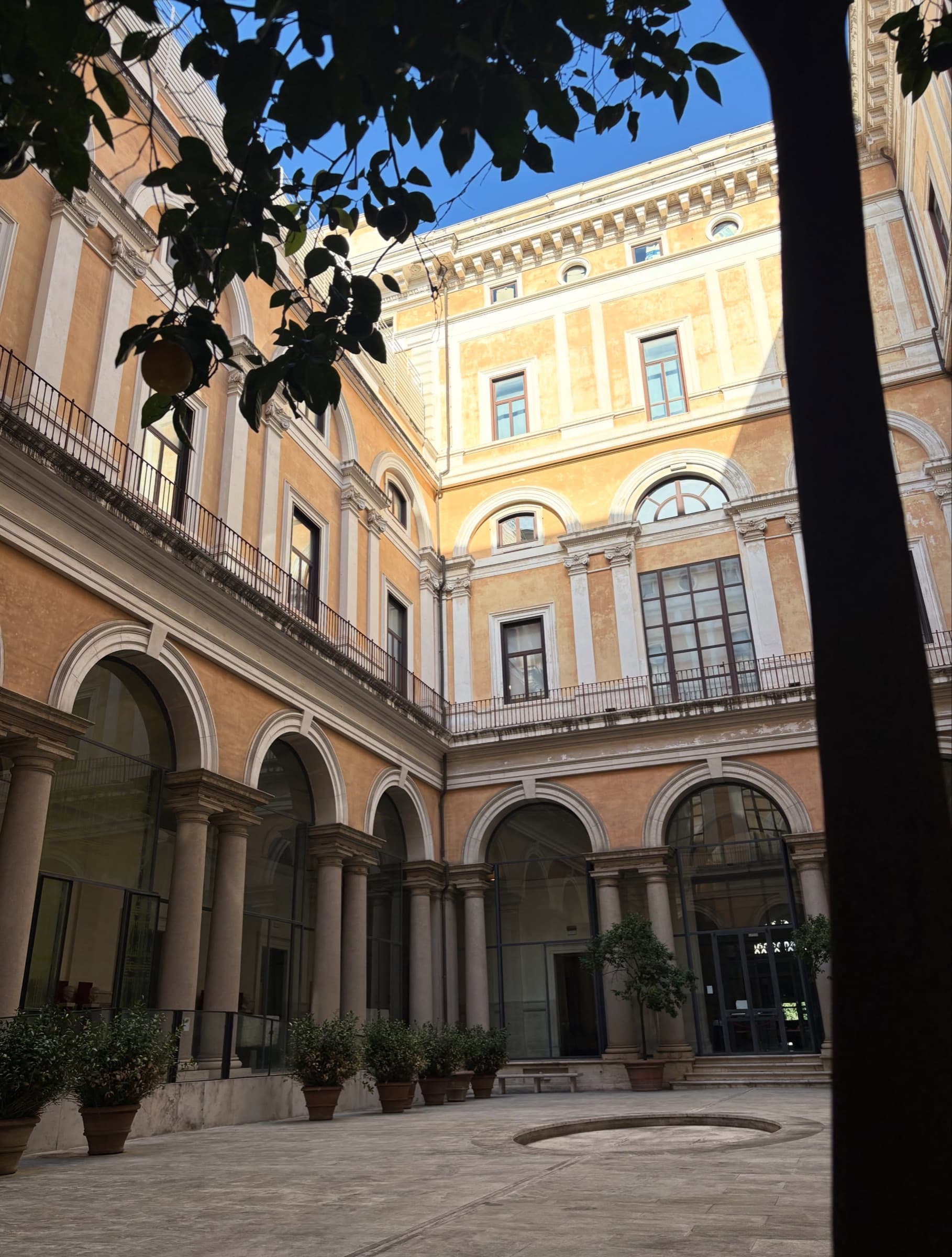 An arcaded courtyard in warm afternoon light