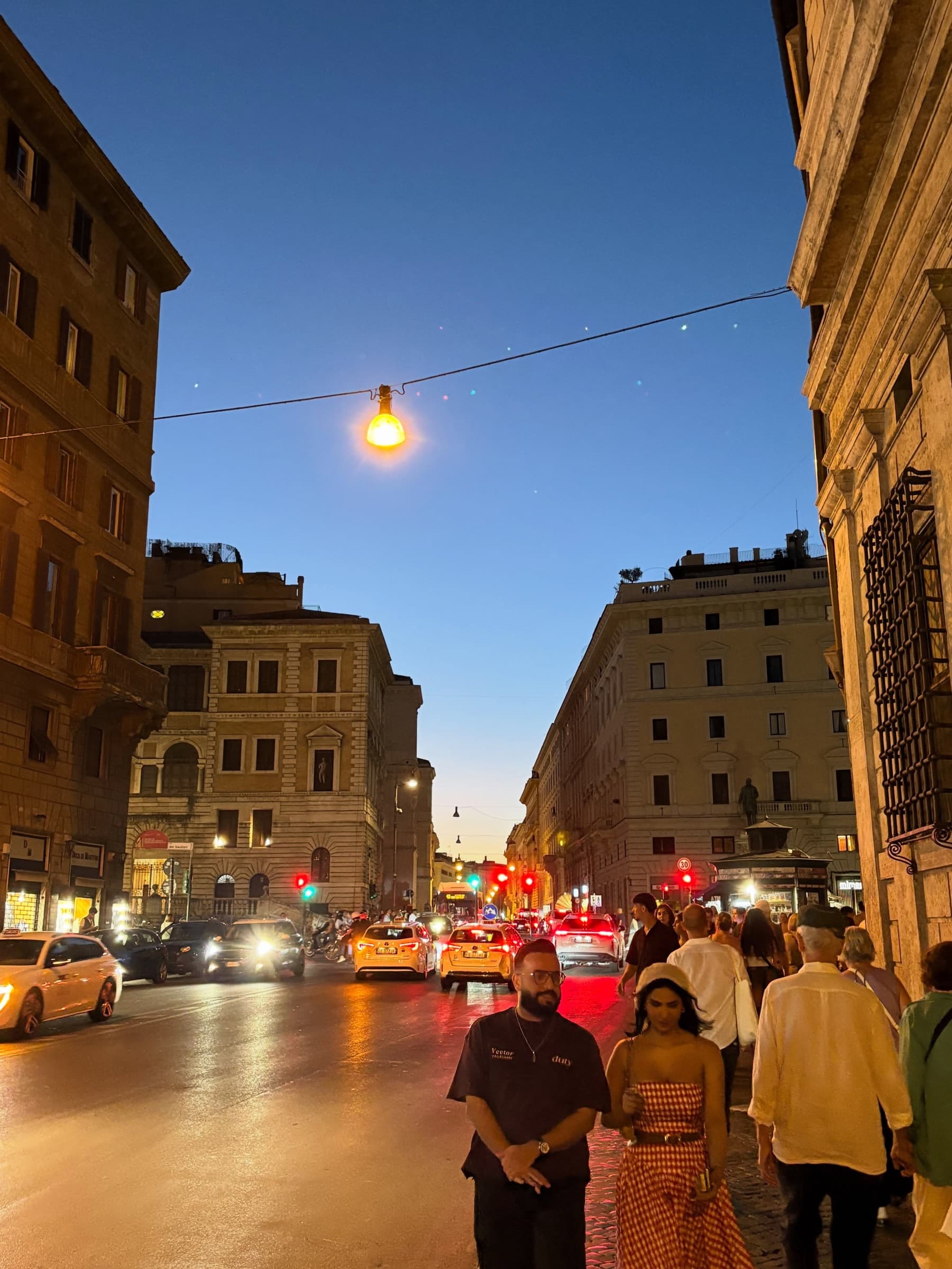 A lively street at blue hour with string lights