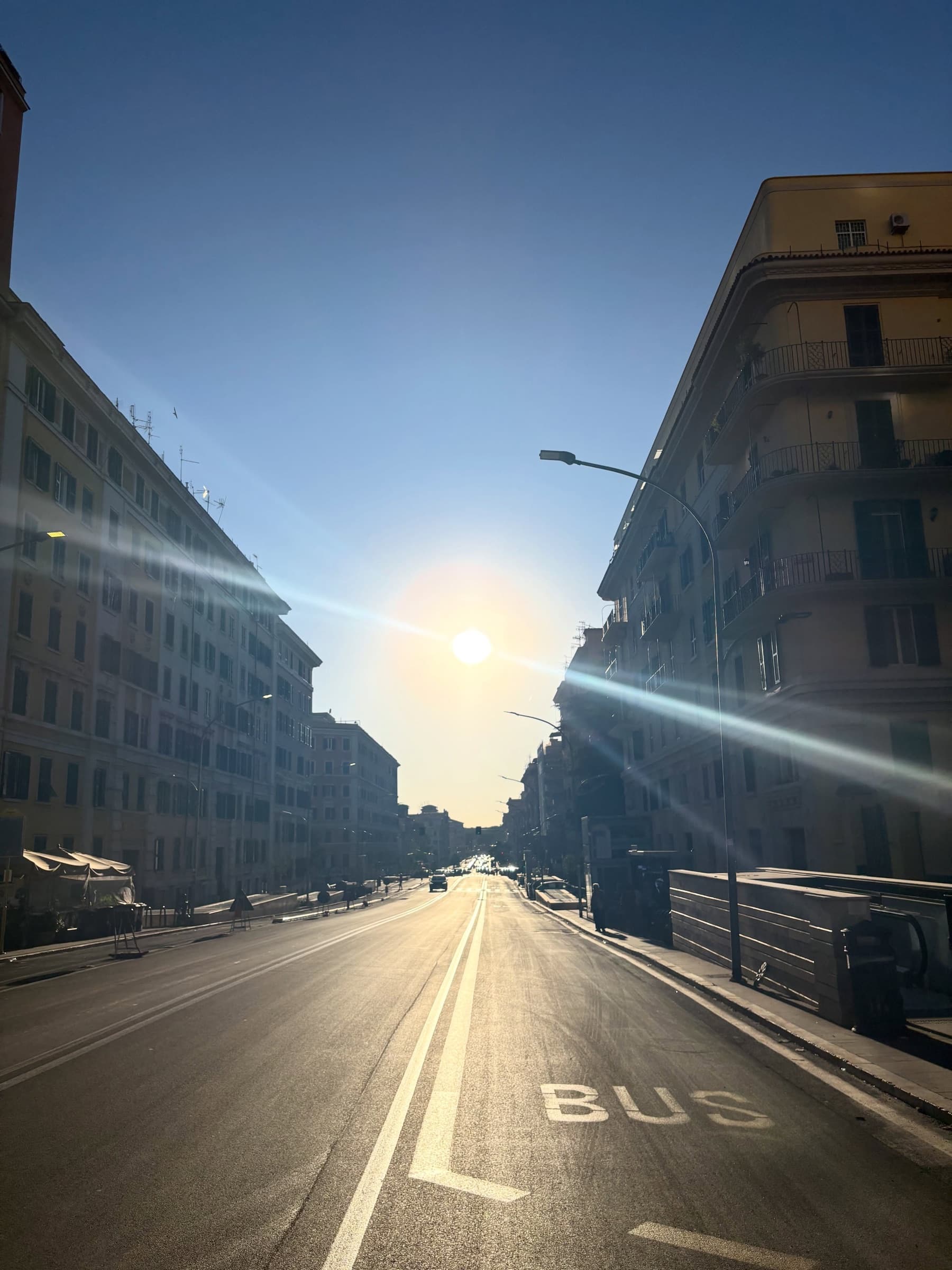 Low sun flaring down an empty street